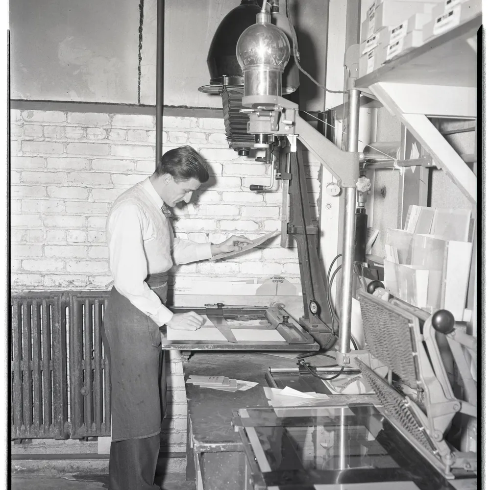 Ford Bowers printing photographs at an auto-focus enlarger, Dow Photographic Laboratory (1947)